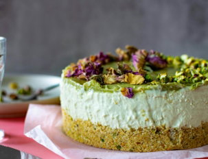 a cake sitting on top of a table next to a glass