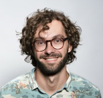 smiling man with glasses and beard portrait